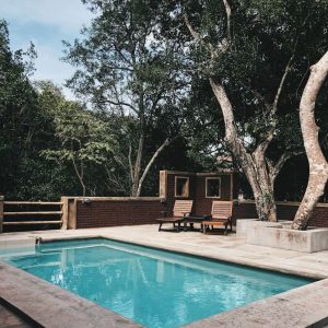 two lounge chairs near swimming pool